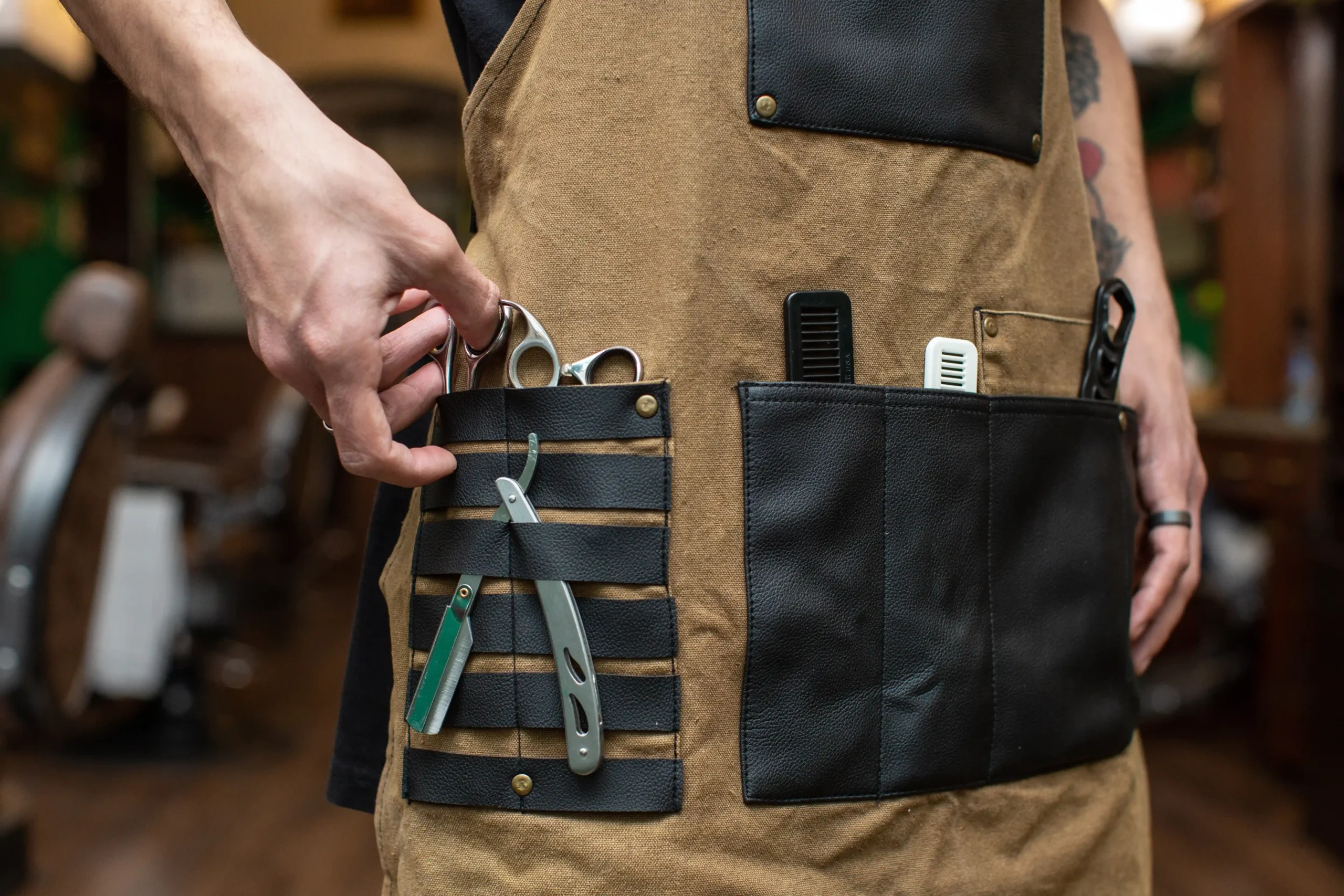 Hairstylist apron packed with scissors, combs, and razors.
